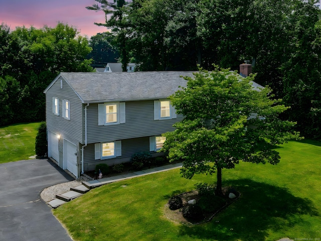 197 Hummingbird Dr, Berlin, CT 06037 - view of front of house featuring driveway, a lawn, and an attached garage