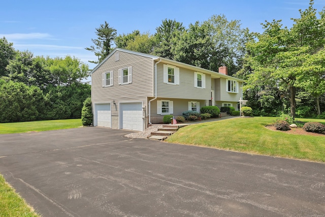 197 Hummingbird Dr, Berlin, CT 06037 - view of front of home with driveway, a chimney, a garage, and a front lawn