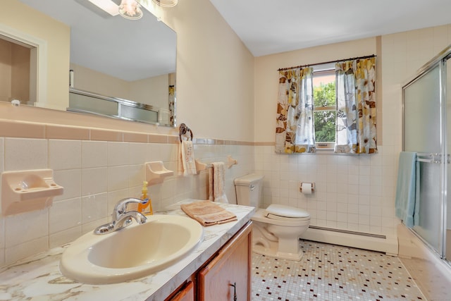 197 Hummingbird Dr, Berlin, CT 06037 - bathroom with a baseboard radiator, tile walls, vanity, toilet, and enclosed tub / shower combo