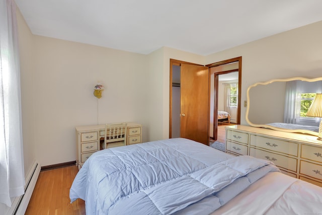 197 Hummingbird Dr, Berlin, CT 06037 - bedroom with a baseboard heating unit, multiple windows, light wood finished floors, and baseboards