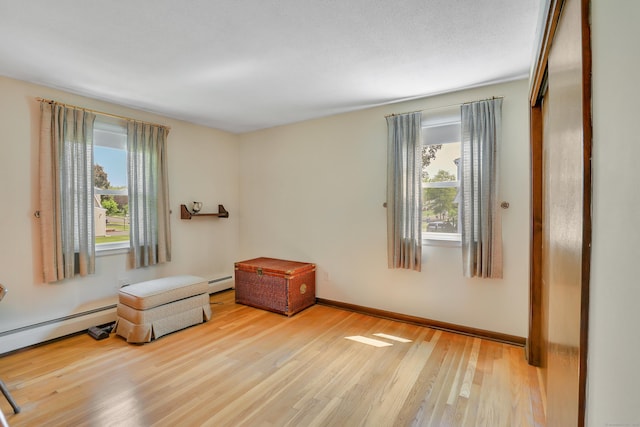 197 Hummingbird Dr, Berlin, CT 06037 - empty room featuring healthy amount of natural light, wood finished floors, a baseboard radiator, and baseboards