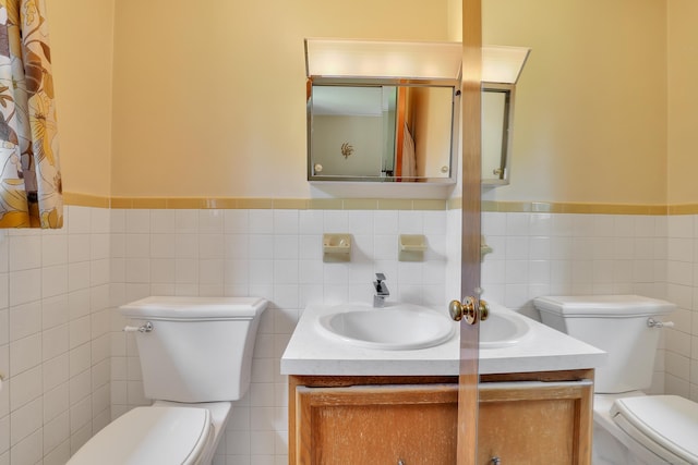 197 Hummingbird Dr, Berlin, CT 06037 - bathroom with toilet, vanity, tile walls, and a wainscoted wall
