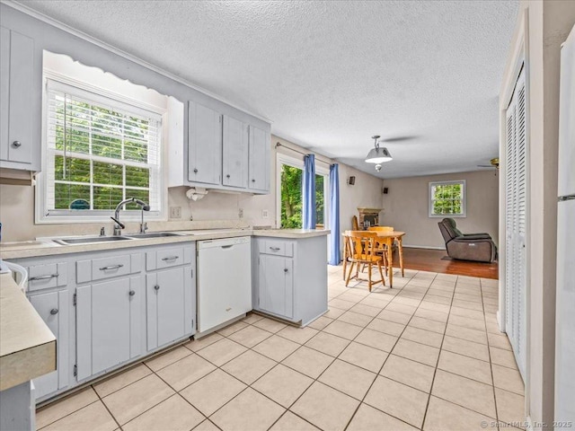 5 Marian Ln, Clinton, CT 06413 - kitchen with white dishwasher, a sink, light countertops, a textured ceiling, and open floor plan