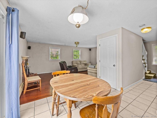 5 Marian Ln, Clinton, CT 06413 - dining space with light tile patterned floors, stairs, baseboards, and a textured ceiling