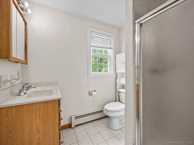 5 Marian Ln, Clinton, CT 06413 - bathroom featuring baseboard heating, tile patterned flooring, vanity, a stall shower, and toilet