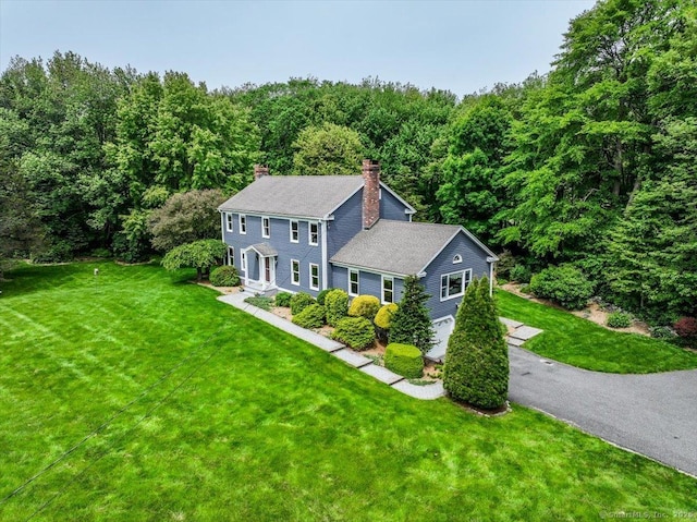 10 Hundred Acres Rd, Newtown, CT 06470 - colonial-style house with a chimney, a view of trees, and a front lawn