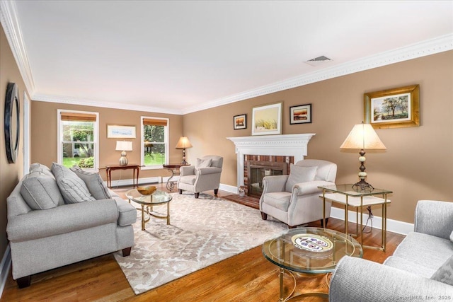 10 Hundred Acres Rd, Newtown, CT 06470 - living area with ornamental molding, baseboards, wood finished floors, and a brick fireplace