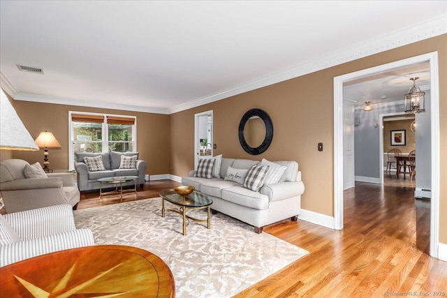 10 Hundred Acres Rd, Newtown, CT 06470 - living area featuring wood finished floors, ornamental molding, baseboards, and a baseboard radiator