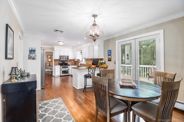 10 Hundred Acres Rd, Newtown, CT 06470 - dining area featuring french doors, dark wood-style floors, crown molding, and a chandelier