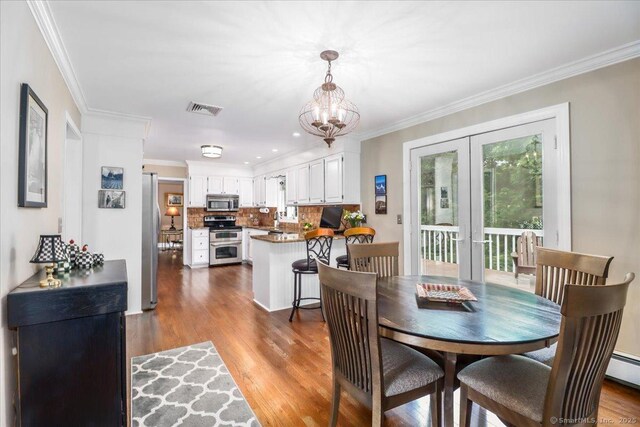 10 Hundred Acres Rd, Newtown, CT 06470 - dining space featuring french doors, dark wood-style floors, ornamental molding, and a chandelier