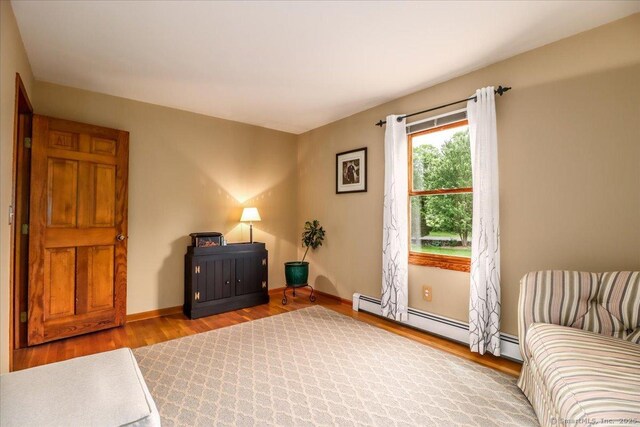 10 Hundred Acres Rd, Newtown, CT 06470 - living area with wood finished floors, baseboards, and a baseboard heating unit