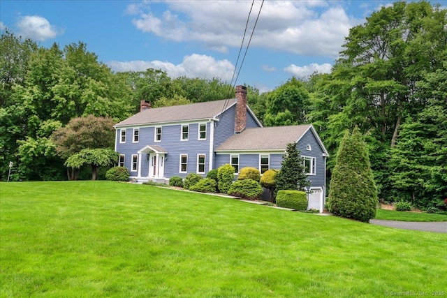 10 Hundred Acres Rd, Newtown, CT 06470 - colonial inspired home with a chimney, a front yard, and a shingled roof