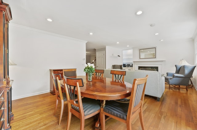 177 S Ave Unit 6, New Canaan, CT 06840 - dining area featuring crown molding, light wood-style flooring, a fireplace, recessed lighting, and baseboards