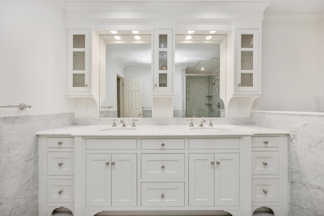 177 S Ave Unit 6, New Canaan, CT 06840 - bathroom with tile walls, a stall shower, double vanity, ornamental molding, and a wainscoted wall