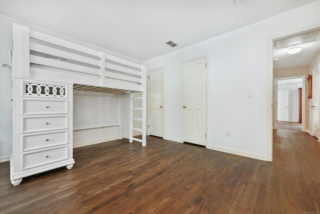 177 S Ave Unit 6, New Canaan, CT 06840 - unfurnished bedroom with wood finished floors, attic access, baseboards, and two closets