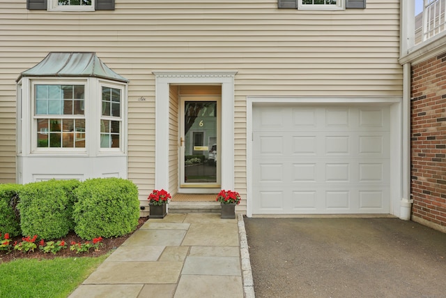 177 S Ave Unit 6, New Canaan, CT 06840 - view of exterior entry with asphalt driveway and a garage