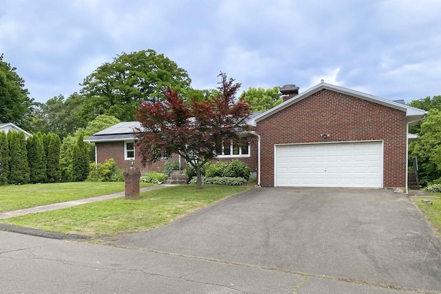 92 Milardo Ln, Middletown, CT 06457 - view of front of home with driveway, solar panels, a front yard, brick siding, and an attached garage