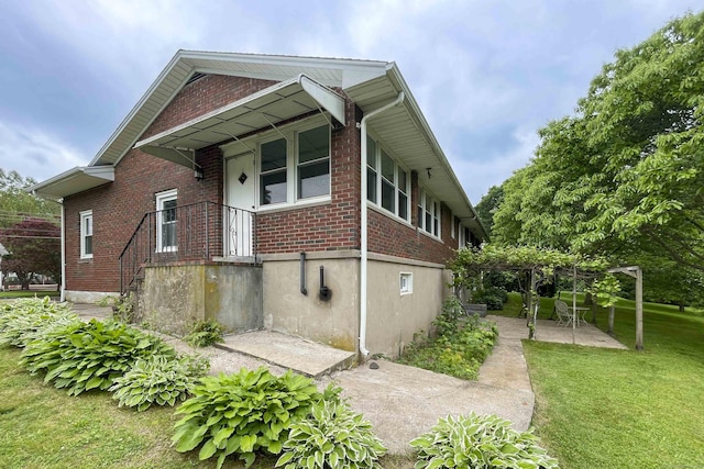 92 Milardo Ln, Middletown, CT 06457 - view of home's exterior featuring brick siding, a lawn, and a patio area