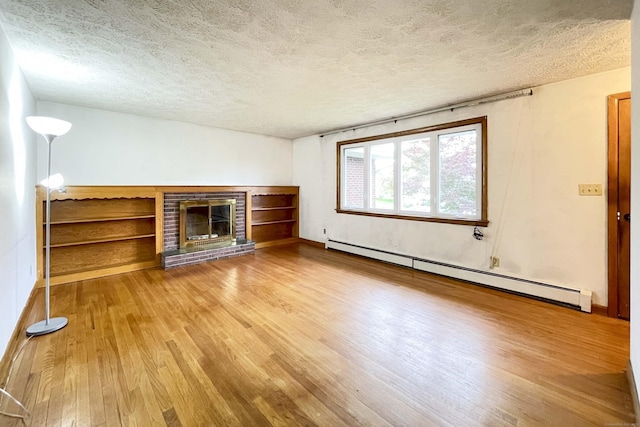 92 Milardo Ln, Middletown, CT 06457 - unfurnished living room featuring a baseboard radiator, a textured ceiling, wood finished floors, a brick fireplace, and baseboards