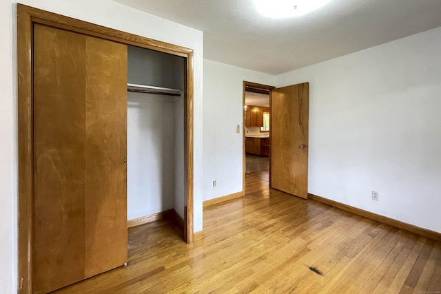92 Milardo Ln, Middletown, CT 06457 - unfurnished bedroom featuring light wood-type flooring, baseboards, and a closet