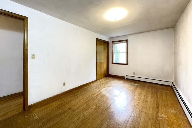 92 Milardo Ln, Middletown, CT 06457 - empty room with baseboard heating, wood finished floors, and baseboards