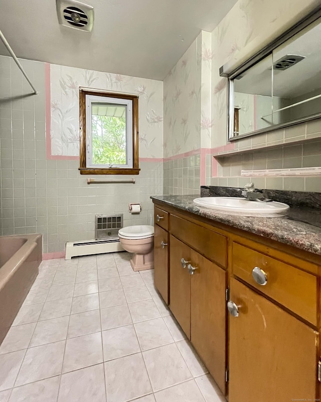 92 Milardo Ln, Middletown, CT 06457 - bathroom with tile walls, a baseboard radiator, vanity, tile patterned flooring, and toilet