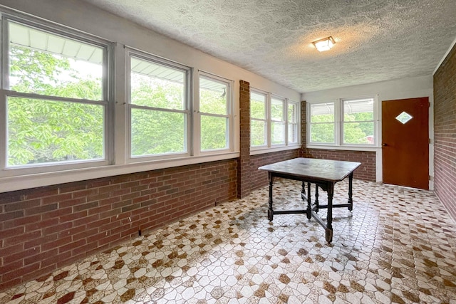 92 Milardo Ln, Middletown, CT 06457 - sunroom / solarium featuring brick wall and a textured ceiling