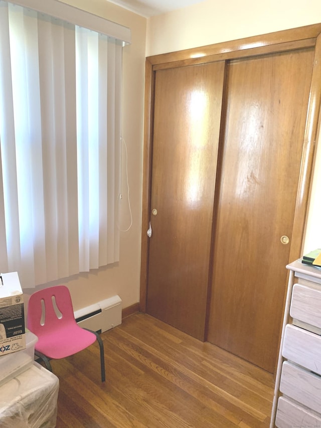 9 Hillcrest Ave, Ledyard, CT 06339 - living area featuring a baseboard heating unit and wood finished floors