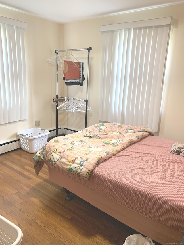 9 Hillcrest Ave, Ledyard, CT 06339 - bedroom with wood finished floors and a baseboard heating unit