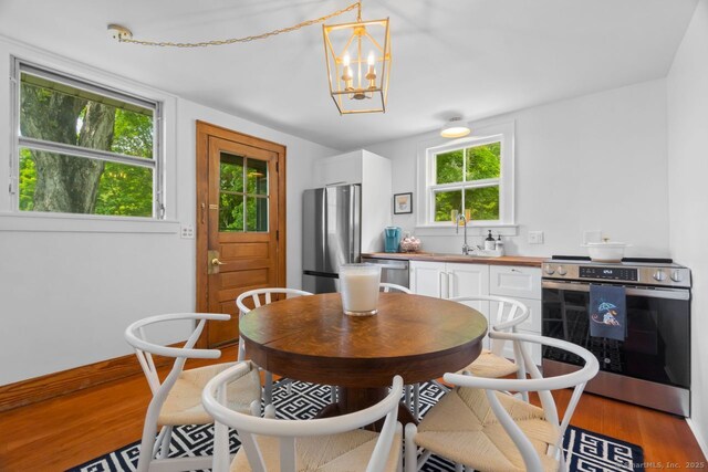 145 Main St, Essex, CT 06442 - dining room with plenty of natural light, light wood finished floors, and a chandelier