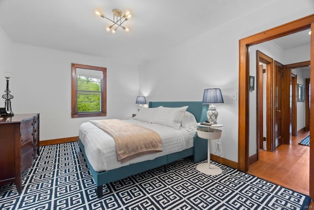 145 Main St, Essex, CT 06442 - bedroom with baseboards, a chandelier, and wood finished floors