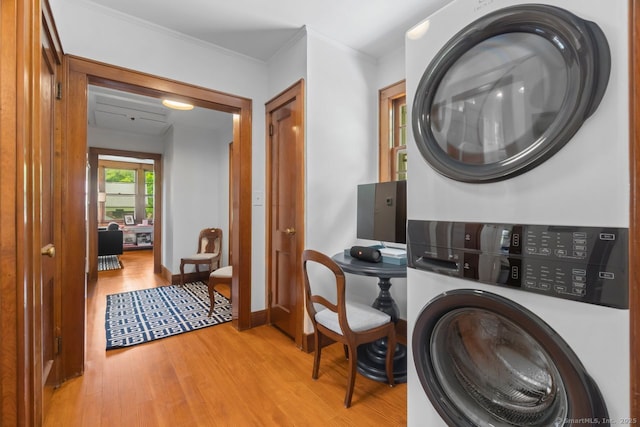 145 Main St, Essex, CT 06442 - laundry room with stacked washer / drying machine, light wood-style flooring, baseboards, and crown molding
