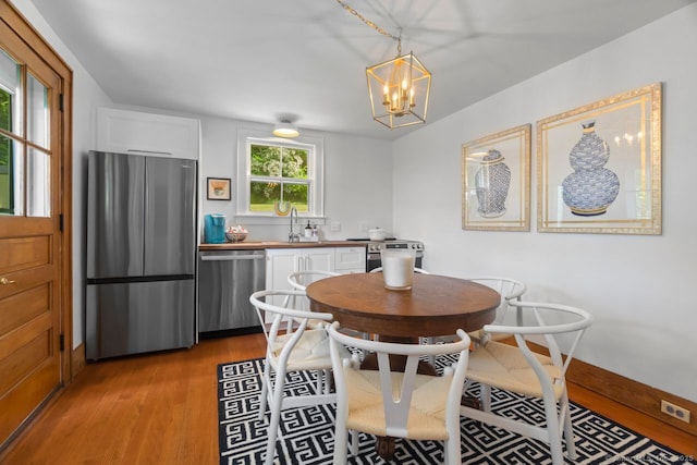 145 Main St, Essex, CT 06442 - dining area featuring light wood-style floors, a chandelier, and baseboards