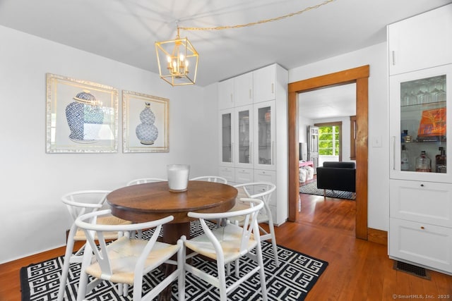 145 Main St, Essex, CT 06442 - dining room featuring a chandelier, wood finished floors, and baseboards