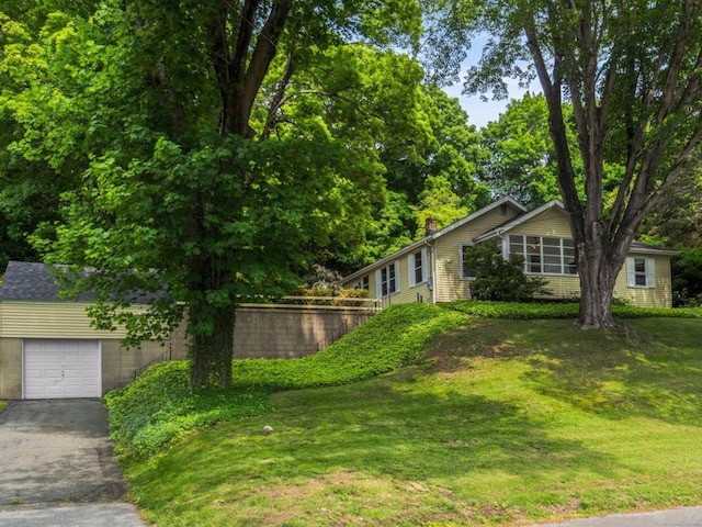 145 Main St, Essex, CT 06442 - view of green lawn with driveway and an attached garage