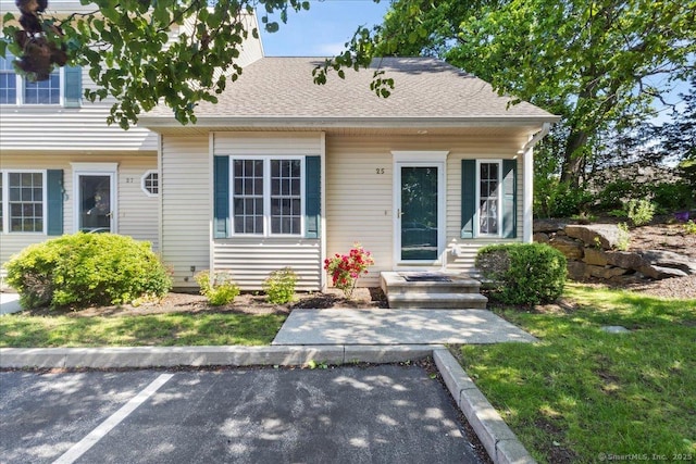 25 Briar Ln Unit 25, Norwich, CT 06360 - view of front of house with uncovered parking, a front yard, and roof with shingles