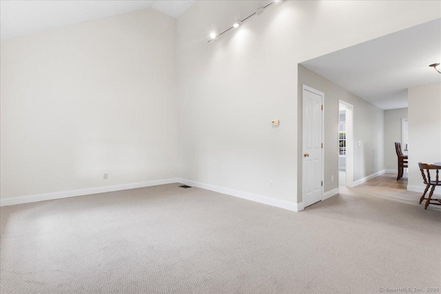 25 Briar Ln Unit 25, Norwich, CT 06360 - spare room featuring light carpet, baseboards, track lighting, and high vaulted ceiling