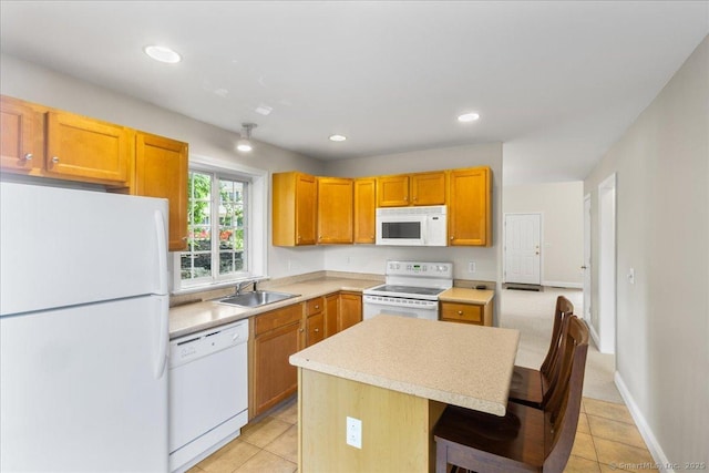 25 Briar Ln Unit 25, Norwich, CT 06360 - kitchen with white appliances, a sink, a center island, light countertops, and light tile patterned flooring