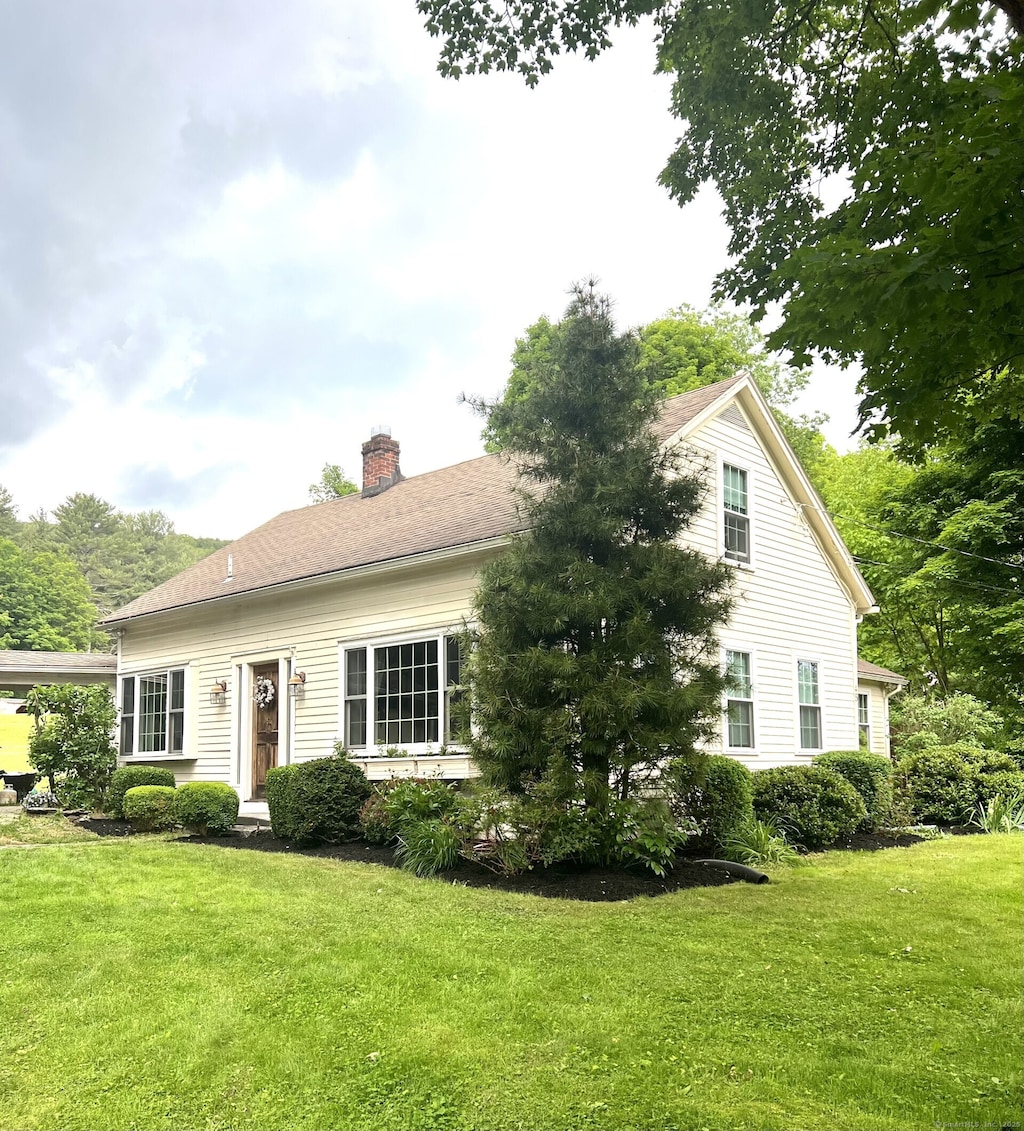 45 Stedman Rd, New Hartford, CT 06057 - view of front facade featuring a chimney and a front yard