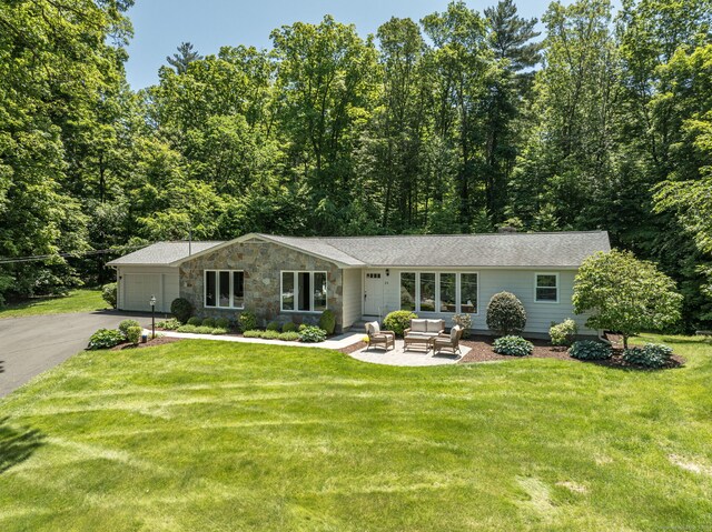 24 Sky Ridge Dr, Somers, CT 06071 - view of front facade with outdoor lounge area, driveway, a front yard, an attached garage, and stone siding