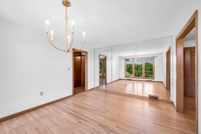24 Sky Ridge Dr, Somers, CT 06071 - unfurnished living room with light wood-style floors, a chandelier, and baseboards