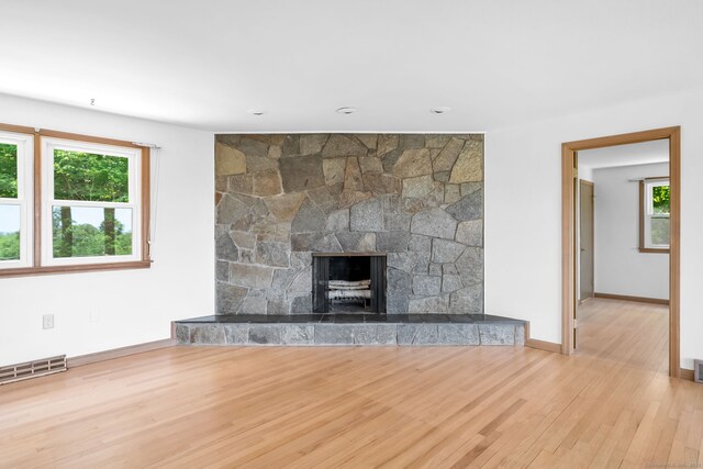 24 Sky Ridge Dr, Somers, CT 06071 - unfurnished living room with wood finished floors, baseboards, and a stone fireplace