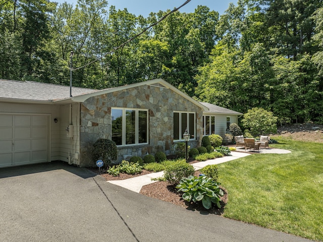 24 Sky Ridge Dr, Somers, CT 06071 - view of front facade with stone siding, a garage, a front yard, driveway, and a shingled roof