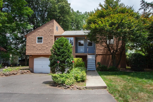 6 Cadwell St, West Hartford, CT 06107 - view of front of property with an attached garage, stairs, and driveway