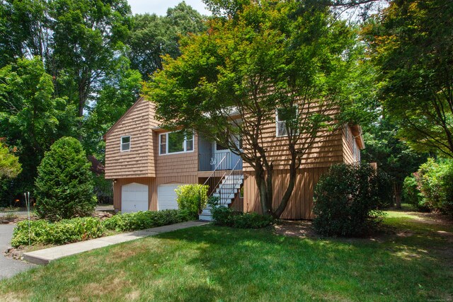 6 Cadwell St, West Hartford, CT 06107 - view of front of home with stairs, an attached garage, and a front lawn