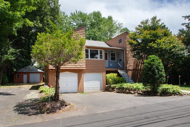 6 Cadwell St, West Hartford, CT 06107 - view of front of property with a garage, stairs, and asphalt driveway