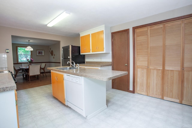 6 Cadwell St, West Hartford, CT 06107 - kitchen with freestanding refrigerator, white dishwasher, light flooring, and light countertops
