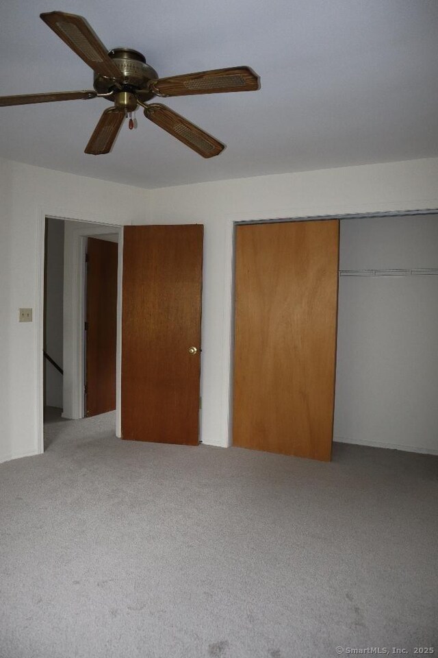 155 Jackson St, Ansonia, CT 06401 - unfurnished bedroom with carpet flooring, a closet, and a ceiling fan