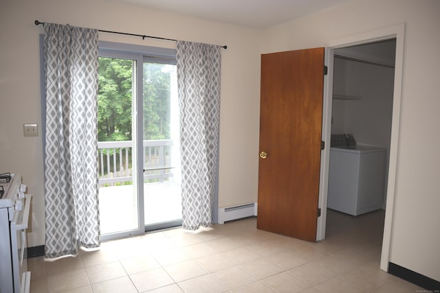 155 Jackson St, Ansonia, CT 06401 - unfurnished bedroom featuring a baseboard radiator, washer / dryer, access to outside, a spacious closet, and light tile patterned floors