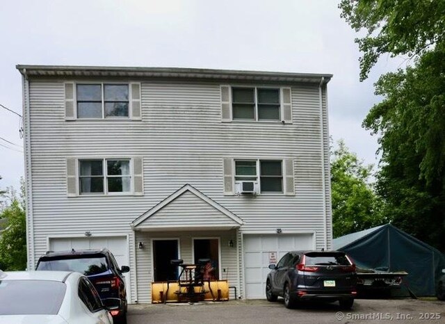 155 Jackson St, Ansonia, CT 06401 - traditional-style home with a garage, asphalt driveway, and cooling unit